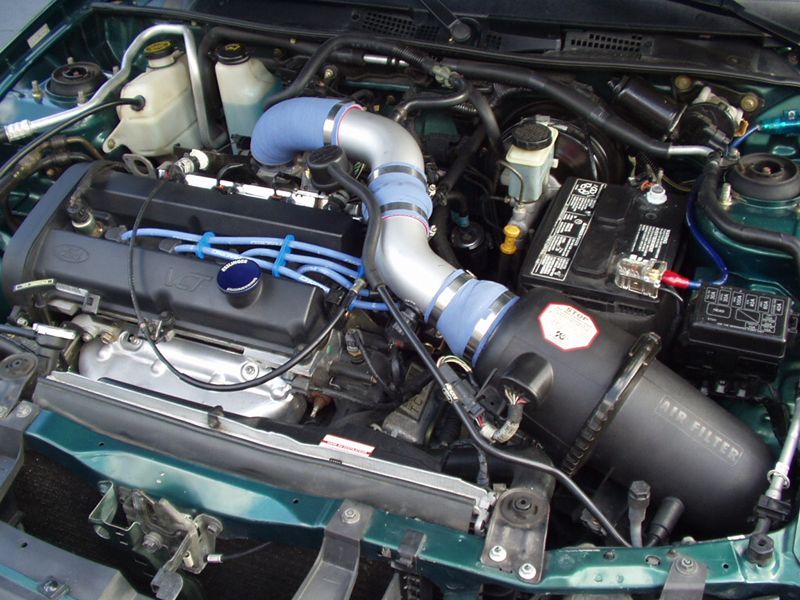 Green ZX2 engine bay with a silver intake tube, blue couplers and an aftermarket airbox