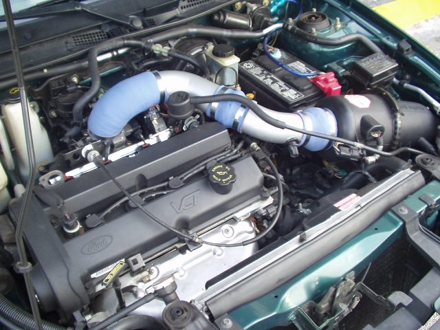 Engine bay of a green ZX2 with the Roush intake tube fitted